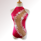 Pink leotard with floral lace details on a mannequin against a white background
